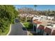 Charming street view showcasing well-manicured lawns, beautiful white homes with orange tile roofs, and lush greenery at 7121 E Mcdonald Dr, Paradise Valley, AZ 85253