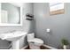 Powder room featuring stylish fixtures, a pedestal sink and modern toilet design at 714 W Desert Hills Dr, San Tan Valley, AZ 85143