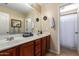 Bright bathroom featuring double sinks, a large mirror, and a separate shower/tub area at 714 W Desert Hills Dr, San Tan Valley, AZ 85143