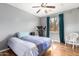 Comfortable bedroom with hardwood floors, a ceiling fan and a bright window at 714 W Desert Hills Dr, San Tan Valley, AZ 85143