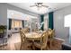 Elegant dining room with decorative chairs, a ceiling fan, and natural light from the window at 714 W Desert Hills Dr, San Tan Valley, AZ 85143