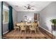 Elegant dining room featuring hardwood floors, a classic table, and a stylish ceiling fan at 714 W Desert Hills Dr, San Tan Valley, AZ 85143