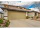 Charming two-story home with tan stucco, a tile roof, three-car garage and manicured landscaping at 714 W Desert Hills Dr, San Tan Valley, AZ 85143