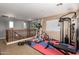Upstairs home gym featuring workout equipment, weights, rubber floors and natural light at 714 W Desert Hills Dr, San Tan Valley, AZ 85143