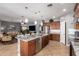Modern kitchen with granite countertops, stainless steel appliances, and an open view to the living area at 714 W Desert Hills Dr, San Tan Valley, AZ 85143