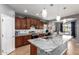 Modern kitchen with granite countertops, stainless steel appliances, and a center island at 714 W Desert Hills Dr, San Tan Valley, AZ 85143