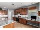 Spacious kitchen featuring stainless steel appliances, granite countertops, and tile flooring at 714 W Desert Hills Dr, San Tan Valley, AZ 85143