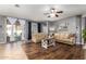 Inviting living room featuring comfortable seating, hardwood floors, and sliding glass doors to the backyard at 714 W Desert Hills Dr, San Tan Valley, AZ 85143