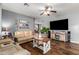 Spacious living room with hardwood floors, comfortable seating, and a modern entertainment center at 714 W Desert Hills Dr, San Tan Valley, AZ 85143