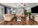 Cozy living room featuring hardwood floors, a comfortable sofa, and a ceiling fan at 714 W Desert Hills Dr, San Tan Valley, AZ 85143