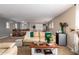 Relaxing living area showcasing plush sofas, a coffee table, exercise equipment, and natural light at 714 W Desert Hills Dr, San Tan Valley, AZ 85143