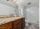 Well-lit bathroom with a modern vanity, granite countertops, and a tiled glass shower at 7751 E Glenrosa Ave # A1, Scottsdale, AZ 85251