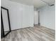 Simple bedroom with a light blue wall, light wood floors, and a large closet at 7751 E Glenrosa Ave # A1, Scottsdale, AZ 85251