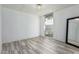 Minimalist bedroom with brick-look walls, light wood floors, and bright window views at 7751 E Glenrosa Ave # A1, Scottsdale, AZ 85251