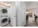 Convenient in-unit laundry area with stacked washer and dryer, adjacent to living space at 7751 E Glenrosa Ave # A1, Scottsdale, AZ 85251