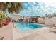 Community pool with lounge area and desert landscaping near white residential buildings and palm trees at 7751 E Glenrosa Ave # A1, Scottsdale, AZ 85251