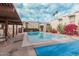 Community pool with lounge area and desert landscaping near white residential buildings and palm trees at 7751 E Glenrosa Ave # A1, Scottsdale, AZ 85251
