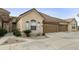 Charming home exterior with a three-car garage and well-manicured landscaping at 7909 E Broadway Rd # 2, Mesa, AZ 85208