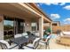 Covered patio features a dining table, lounge seating, and access to the hot tub area at 8181 S Pioneer Ct, Gold Canyon, AZ 85118