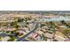 Neighborhood aerial shot showcasing lush landscaping, pools, and solar panels with a park and lake view at 8335 W Berridge Ln, Glendale, AZ 85305