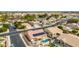 An aerial view of a residential community with houses that have pools, solar panels, and well-maintained landscaping at 8335 W Berridge Ln, Glendale, AZ 85305