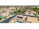 A beautiful aerial view of a neighborhood featuring homes with pools, patios, solar panels, and well-kept landscaping at 8335 W Berridge Ln, Glendale, AZ 85305