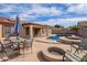 Beautiful backyard featuring a sparkling pool, covered patio, and outdoor seating perfect for entertaining at 8335 W Berridge Ln, Glendale, AZ 85305