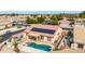 Secluded backyard offering a swimming pool, covered patio, and mature palm trees for added privacy at 8335 W Berridge Ln, Glendale, AZ 85305