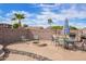 Inviting backyard with a fire pit, seating, string lights and desert landscaping creating an outdoor oasis at 8335 W Berridge Ln, Glendale, AZ 85305