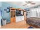 This bedroom has blue walls, a ceiling fan, storage, a TV, and laminate wood flooring at 8335 W Berridge Ln, Glendale, AZ 85305