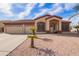 Inviting single-story home featuring a three-car garage and manicured desert landscaping at 8335 W Berridge Ln, Glendale, AZ 85305