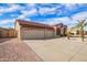 Attractive home featuring a three-car garage and a low-maintenance desert front yard at 8335 W Berridge Ln, Glendale, AZ 85305