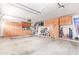 Spacious garage with abundant cabinet storage and overhead shelving to keep everything organized and accessible at 8335 W Berridge Ln, Glendale, AZ 85305
