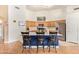 Kitchen with stainless steel appliances, wood cabinets, and a large kitchen island featuring barstool seating at 8335 W Berridge Ln, Glendale, AZ 85305