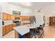 Bright kitchen featuring stainless steel appliances, wooden cabinets and a large island with bar seating at 8335 W Berridge Ln, Glendale, AZ 85305