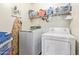 Well-equipped laundry room with modern washer and dryer, shelving, and ample space for organization at 8335 W Berridge Ln, Glendale, AZ 85305