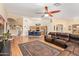 Bright living room with a ceiling fan, breakfast bar, and open access to the kitchen at 8335 W Berridge Ln, Glendale, AZ 85305