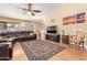 Cozy living room with a ceiling fan, large sofa, and natural light from the window at 8335 W Berridge Ln, Glendale, AZ 85305