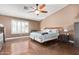 A spacious main bedroom with a ceiling fan, and laminate flooring at 8335 W Berridge Ln, Glendale, AZ 85305
