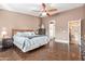 Cozy main bedroom with a ceiling fan, laminate flooring, and access to an en-suite bathroom at 8335 W Berridge Ln, Glendale, AZ 85305