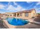 Stunning pool with an attached spa and diving board, surrounded by rock landscaping and desert plants at 8335 W Berridge Ln, Glendale, AZ 85305