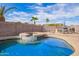 Resort-style pool with a raised spa and lush landscaping in the backyard creates a relaxing oasis at 8335 W Berridge Ln, Glendale, AZ 85305