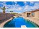 Beautiful backyard featuring a sparkling pool with a spa and lush landscaping, creating a private oasis at 8335 W Berridge Ln, Glendale, AZ 85305