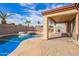 Resort-style pool with a spa, covered patio, and stone deck creates a perfect outdoor living space at 8335 W Berridge Ln, Glendale, AZ 85305