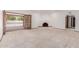 Inviting living room with carpet, fireplace, and doors leading to the pool area at 8476 E Wethersfield Rd, Scottsdale, AZ 85260