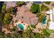 Aerial view of home featuring a large pool, putting green, tennis court, and outdoor living space at 8649 S Willow Dr, Tempe, AZ 85284