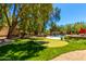 Expansive backyard with a mini golf course, a swimming pool, and a beautiful grassy area at 8649 S Willow Dr, Tempe, AZ 85284