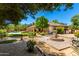 Lush backyard featuring well-manicured landscaping, pool, and charming water fountain at 8649 S Willow Dr, Tempe, AZ 85284