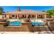 A stunning backyard with a large pool, complete with water features and patio furniture at 8649 S Willow Dr, Tempe, AZ 85284