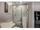 Modern bathroom with a glass-enclosed shower featuring decorative tile and updated fixtures, complete with a neutral color scheme at 8649 S Willow Dr, Tempe, AZ 85284